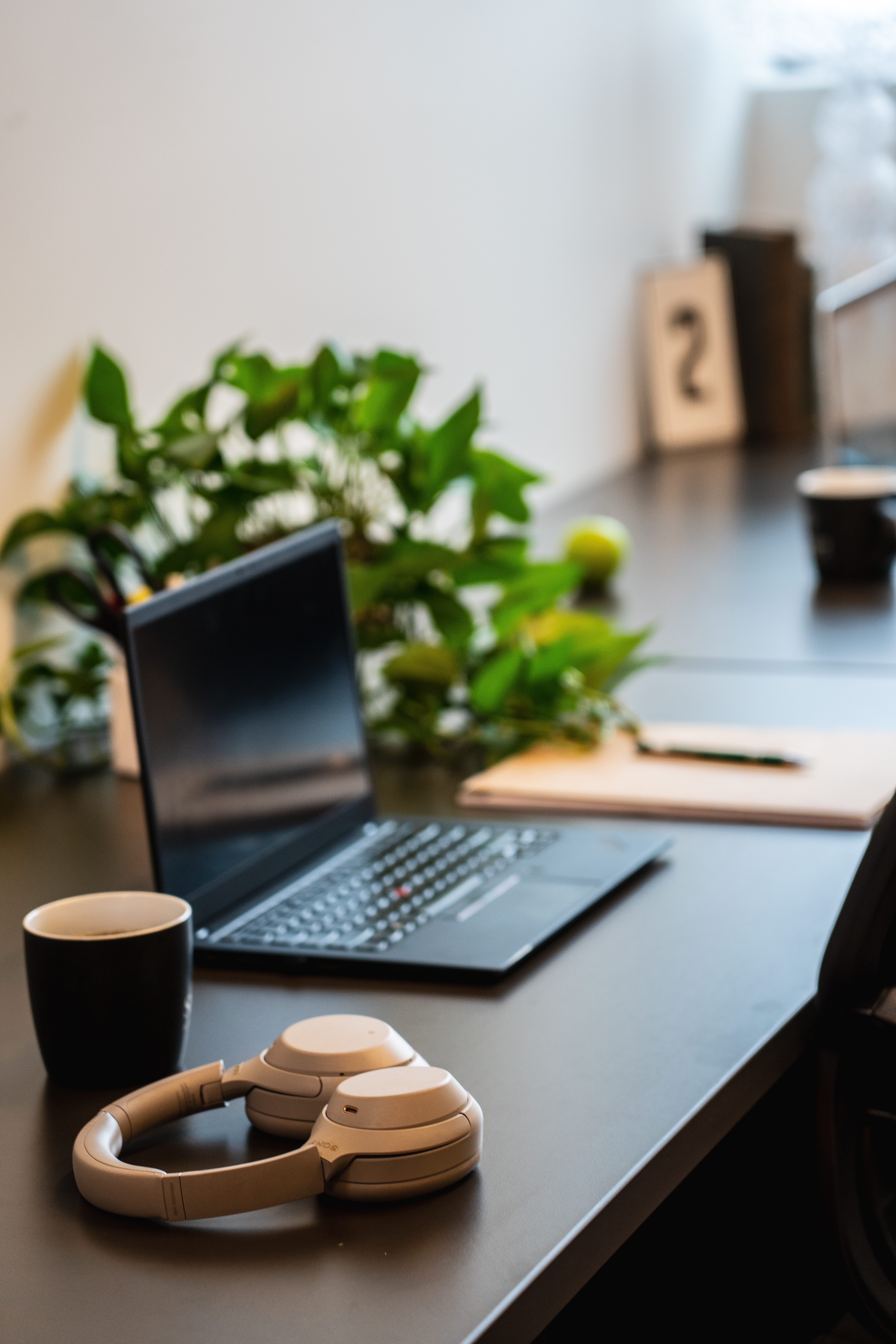 wireless headphones on desk with laptop and shift branded mug