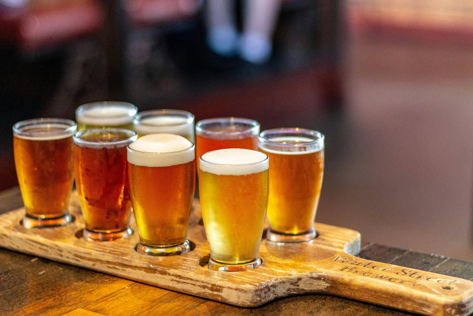 flight of beer for tasting on a wooden board