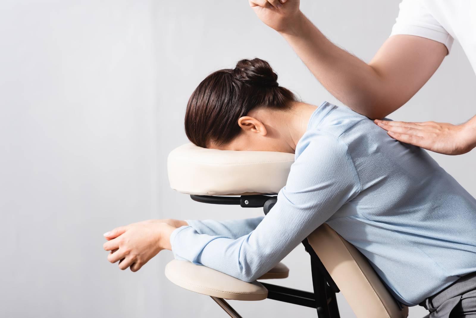 woman in massage chair in blue work shirt