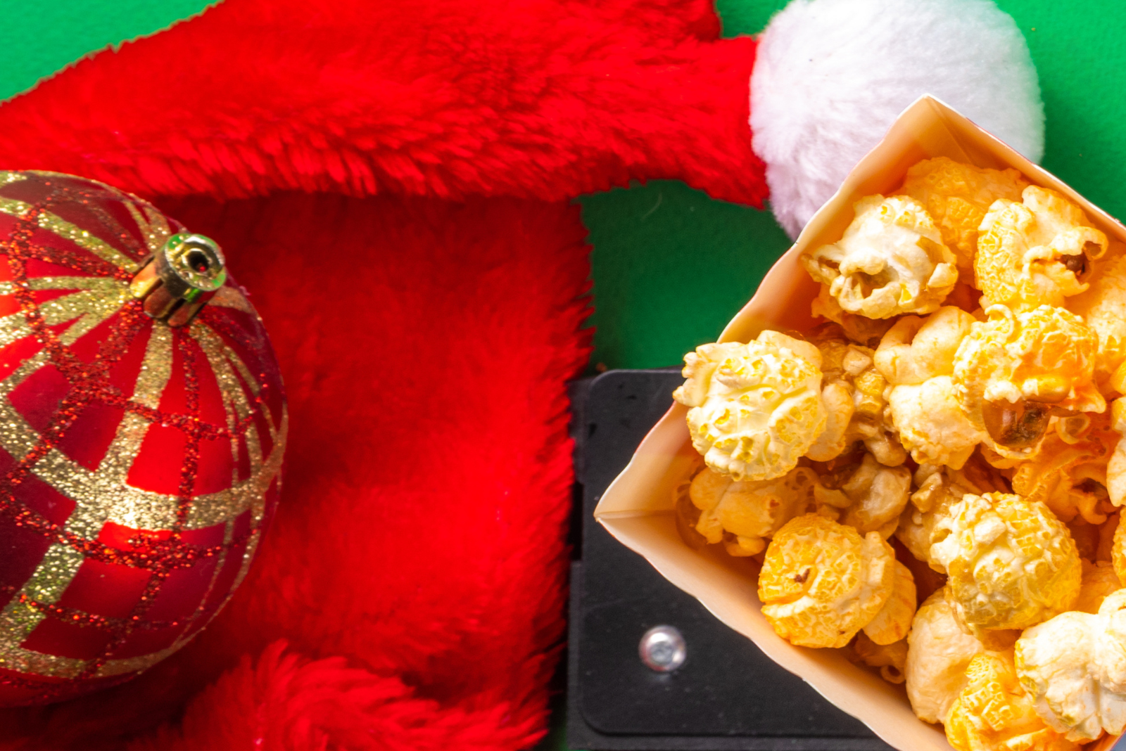 red and gold ornament on top of a santa hat with popcorn