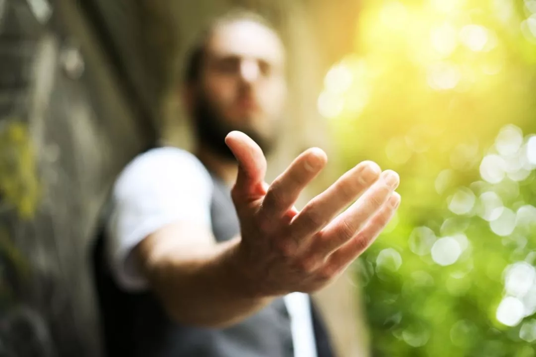 Outstretched hand reaching forward, symbolizing support and connection at Shift Workspaces Denver and Shift Workspaces Littleton.