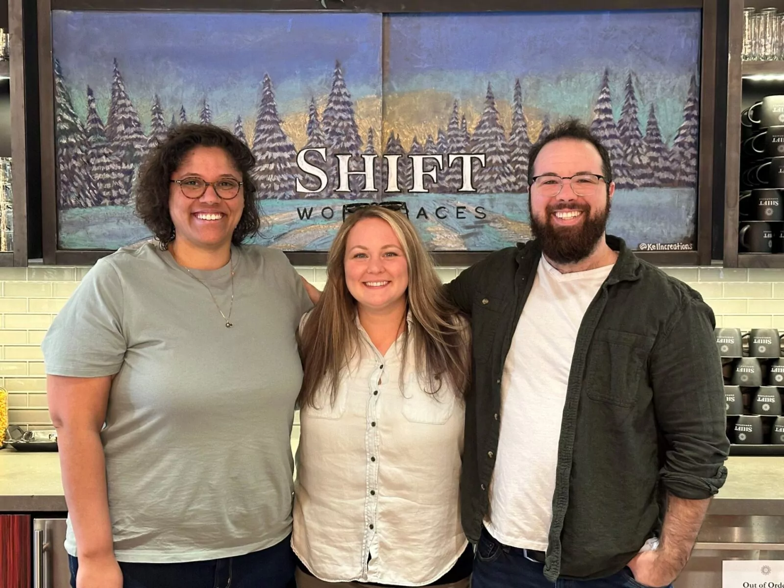 The Scoot Education team smiling in front of the Shift Workspaces mural at Shift Workspaces Denver and Shift Workspaces Littleton.