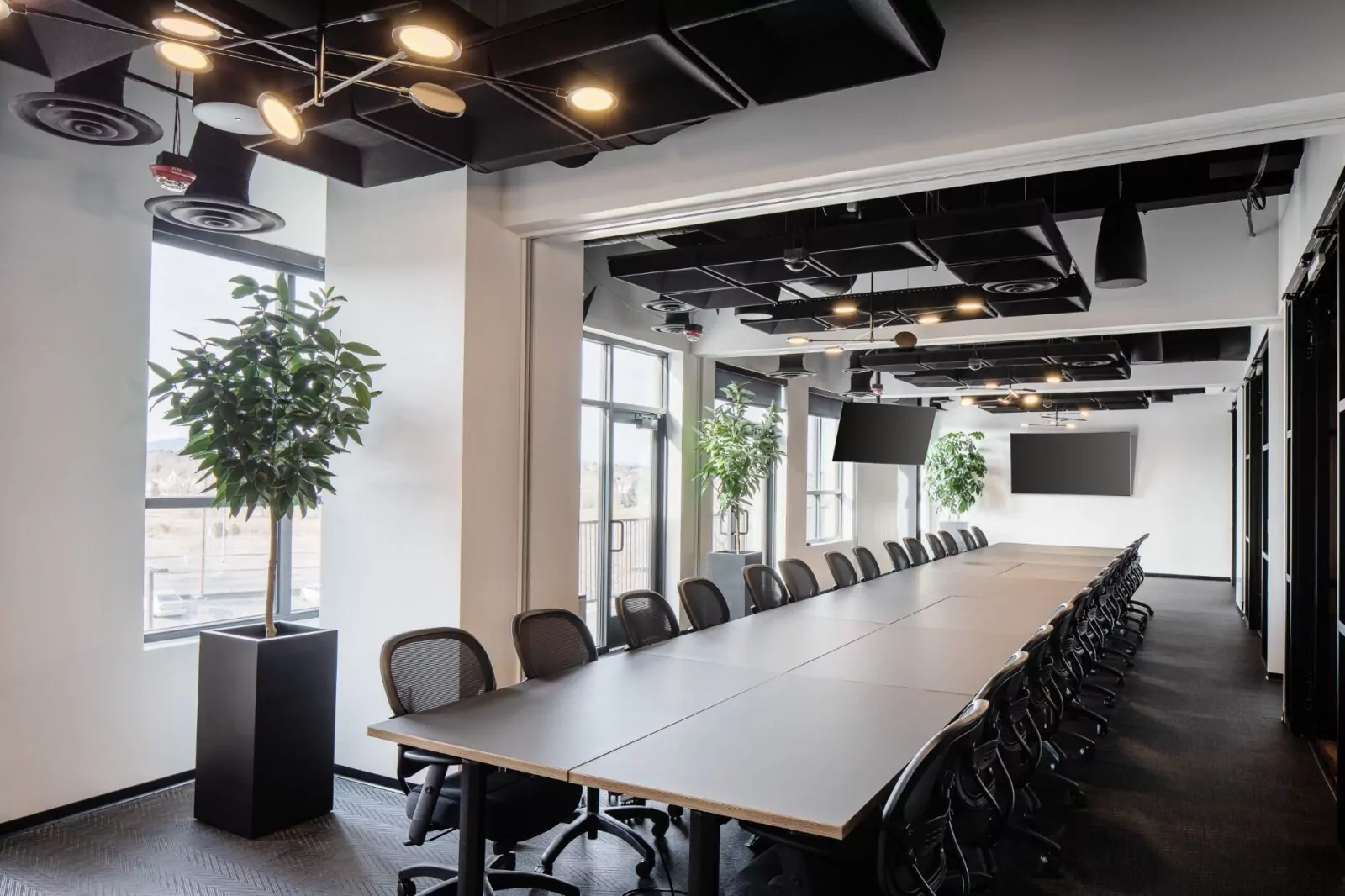 Modern conference room with long meeting table at Shift Workspaces Denver and Shift Workspaces Littleton.