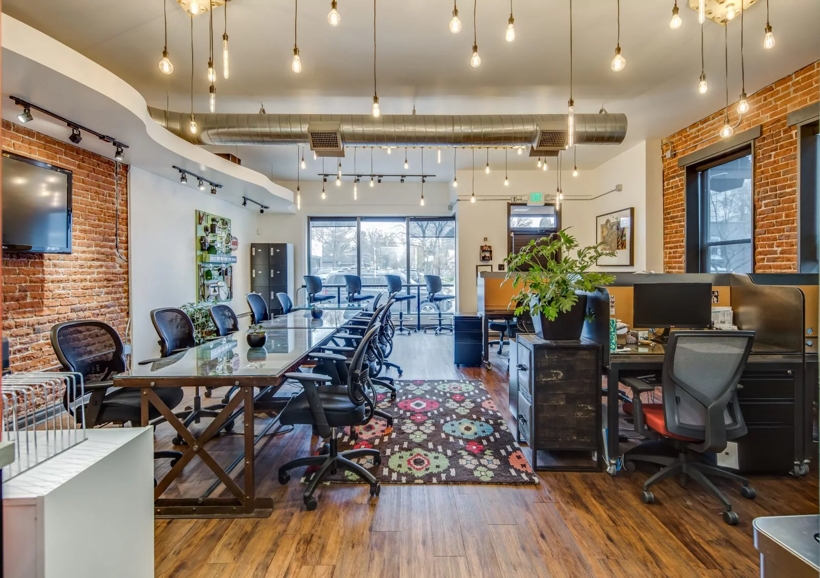 Spacious meeting room with conference table, whiteboard, and video conferencing technology at Shift Workspaces Corona