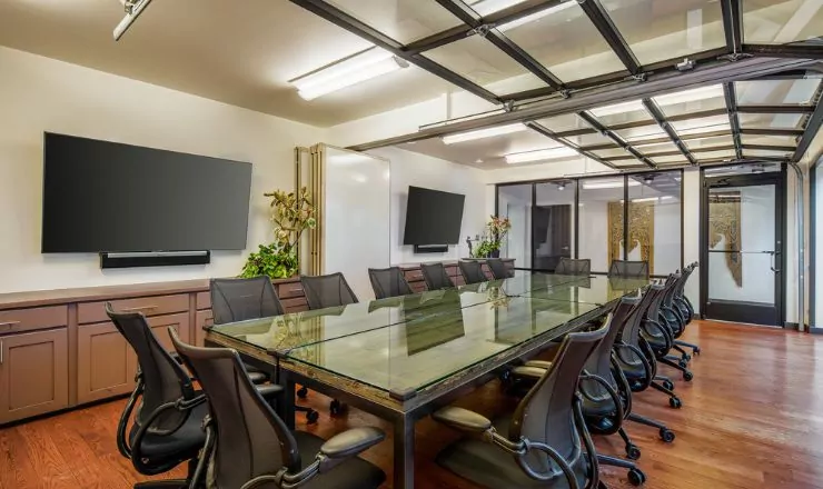 Professional conference room with high-speed internet, a presentation screen, and video conferencing technology.