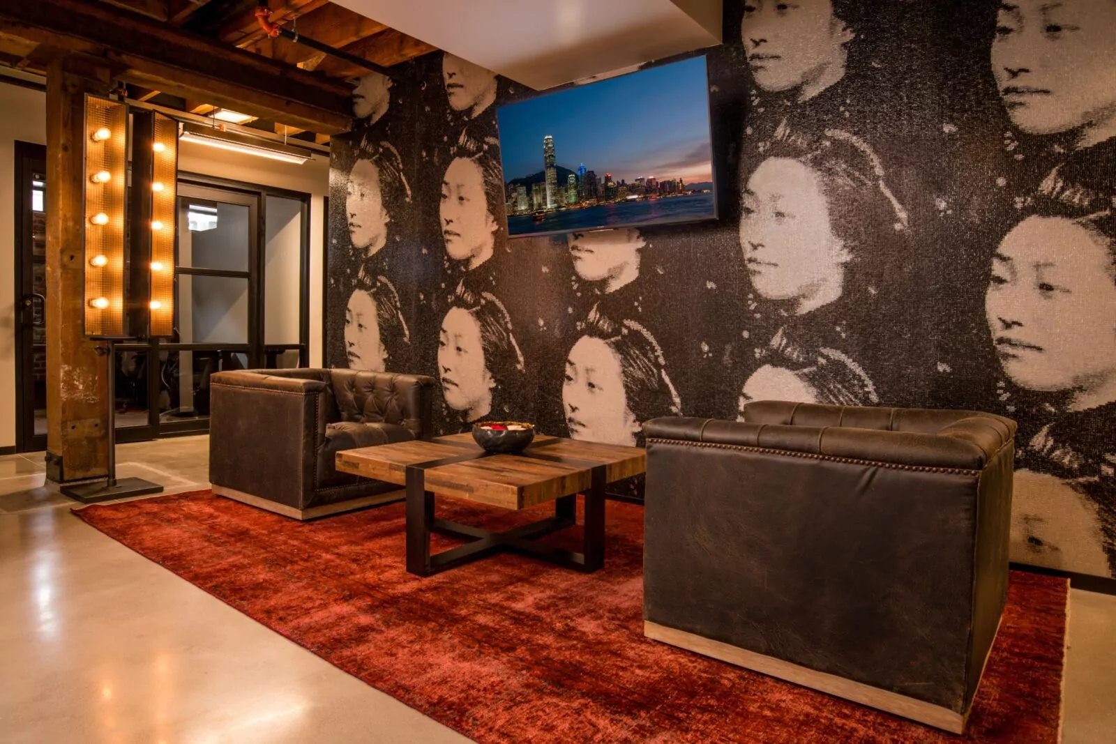 Coworking day pass lounge at Shift Workspaces Denver and Shift Workspaces Littleton with mural and leather chairs