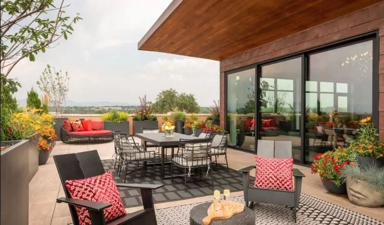 Modern rooftop workspace with cozy seating, greenery, and a relaxing atmosphere.