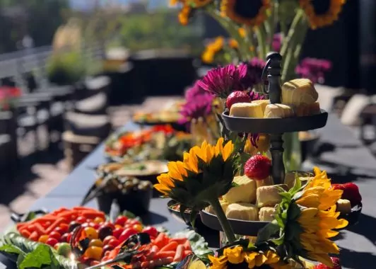 Shift Workspaces happy hour with a delicious snack spread, drinks, and a welcoming community atmosphere.