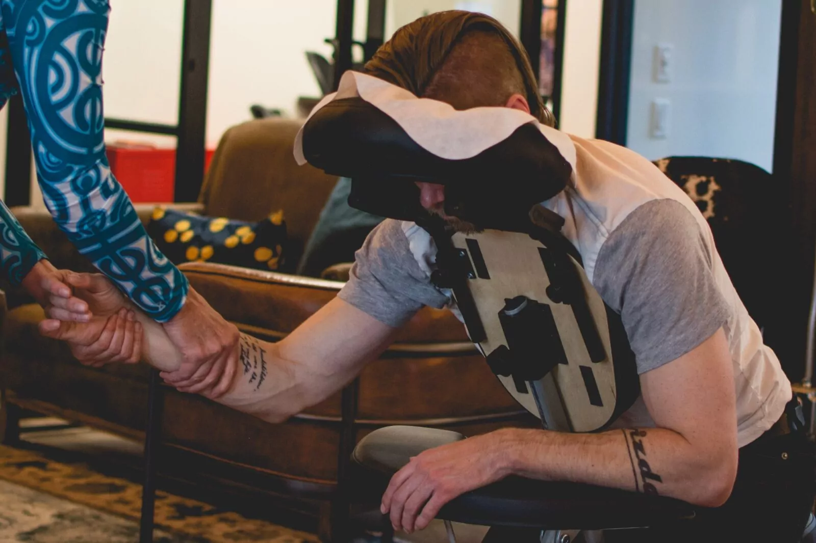 Seated massage session at Shift Workspaces showcasing wellness amenities available at Shift Workspaces Denver and Littleton.