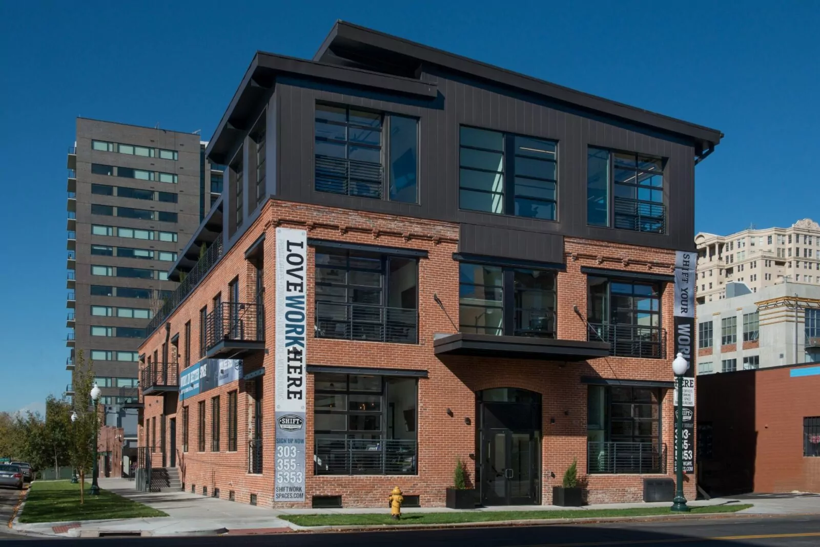 Exterior view of Shift Workspaces Denver building on a sunny day, offering private offices and coworking space in Colorado.