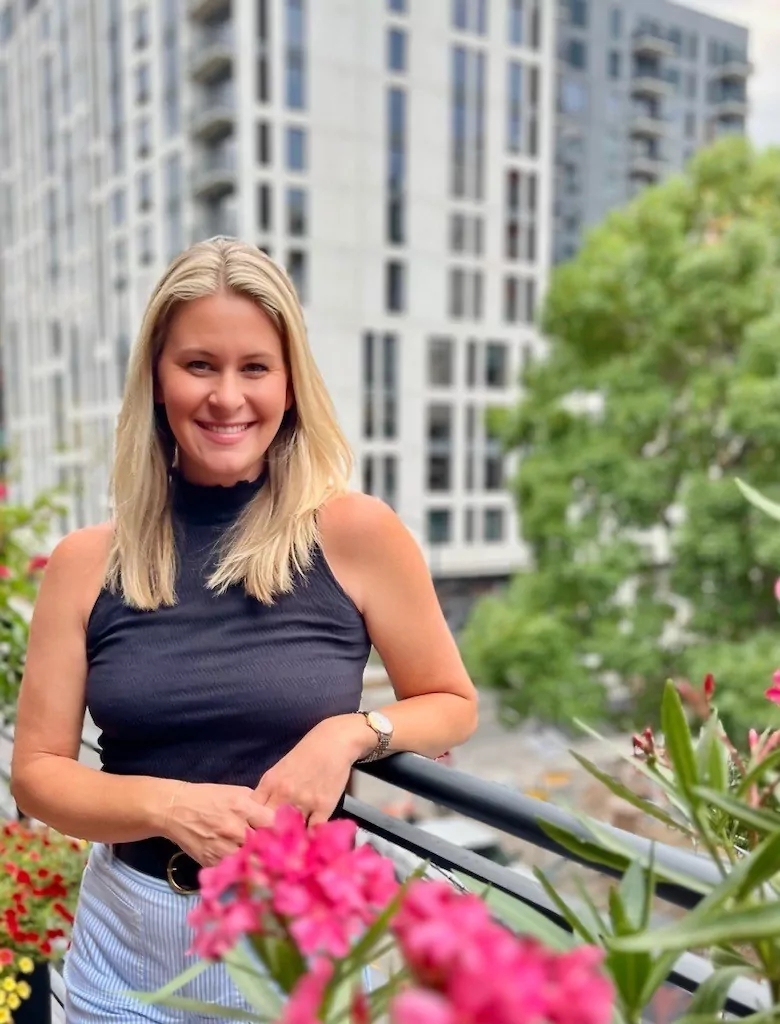 Maggie Clark smiling on the outdoor balcony at Shift Workspaces Denver and Shift Workspaces Littleton.