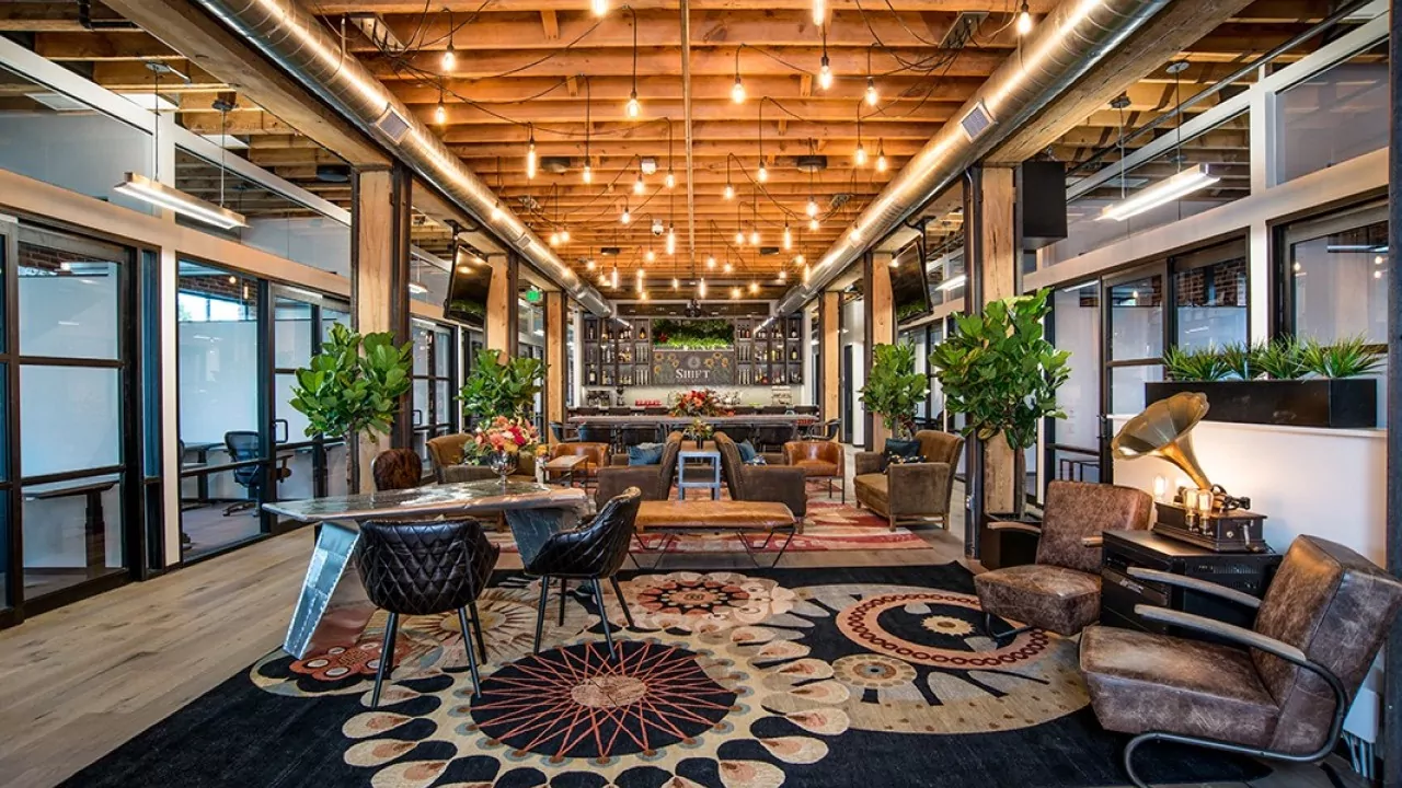 Open lounge area with eclectic decor and coworking desks at Shift Workspaces Denver and Shift Workspaces Littleton.