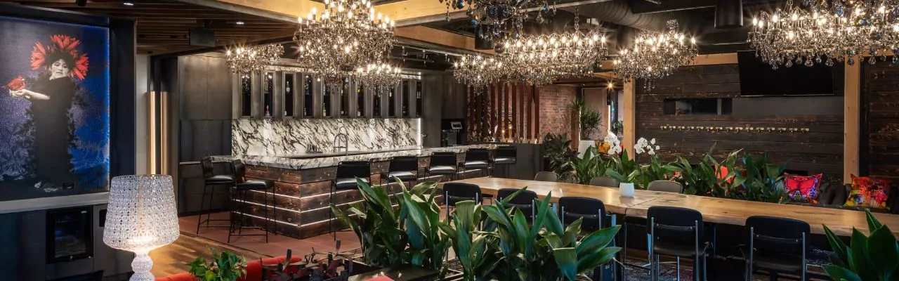 Modern bar area at Shift Workspaces with a long work table, stylish seating, and a collaborative atmosphere