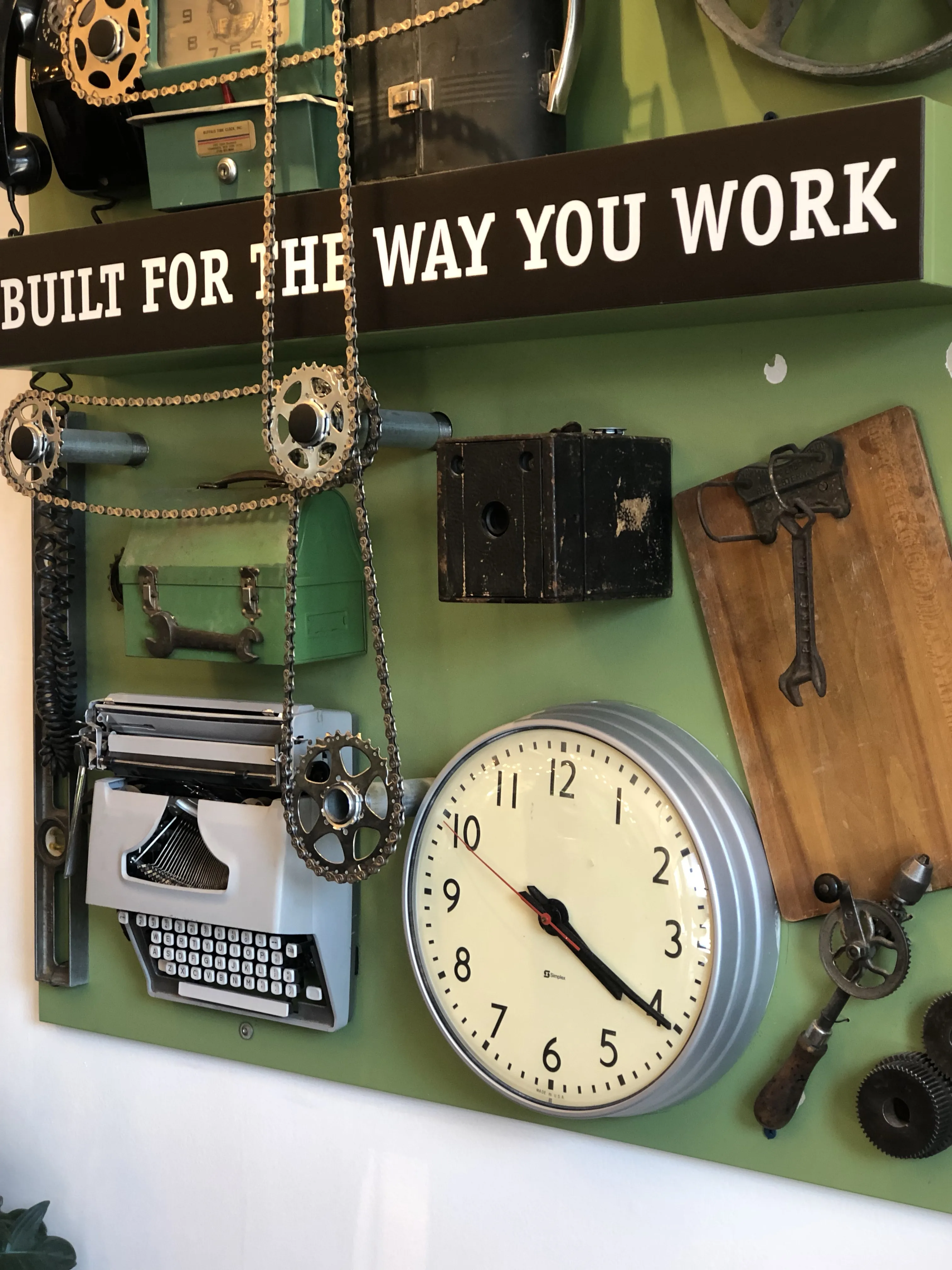 Art installation showcasing a vintage clock and signs